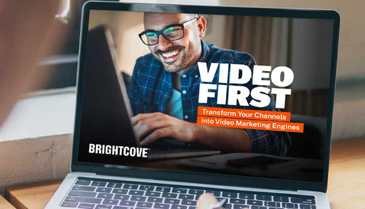 A person is reading Brightcove’s “Video First” guide on a laptop