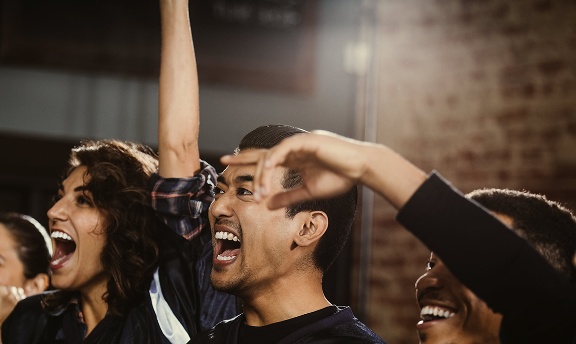 A crowd is cheering at a live event.