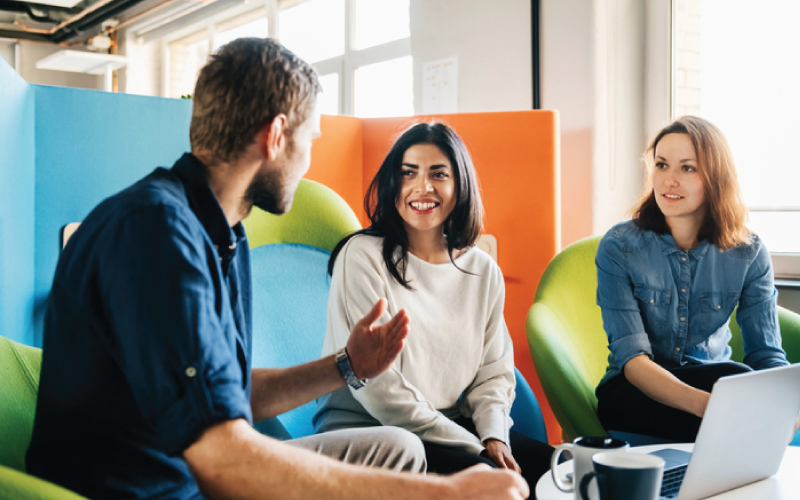 Employees are asking questions during a company welcome meeting