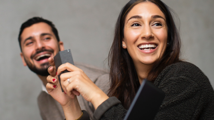 Two employees are collaborating in a company team meeting.